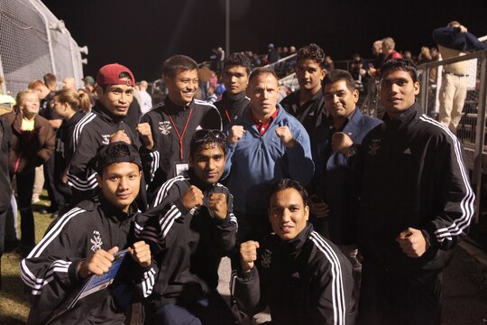 Col. Daniel J. Lecce (center), commanding officer of Marine Corps Base Camp Lejeune, poses as a ‘fierce boxer’ with the Conseil International du Sport Militaire, (International Military Sports Council) boxing team from India, during a CISM cultural day event at the Coastal Plains Raceway, Jacksonville, N.C., Oct. 15. After days of intense competition, CISM athletes and base personnel spent time playing video games, shopping and hanging out at the raceway while exemplifying “Friendship though Sport,” the CISM motto.