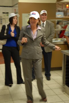 Congresswoman, Susan Davis of California's 53rd congressional district, dons an AbilityOne baseball hat while touring the recruit chow hall of MCRD San Diego.  The recruit chow hall is just one of the facilities on the depot staffed and supported by The ARC of San Diego program participants.