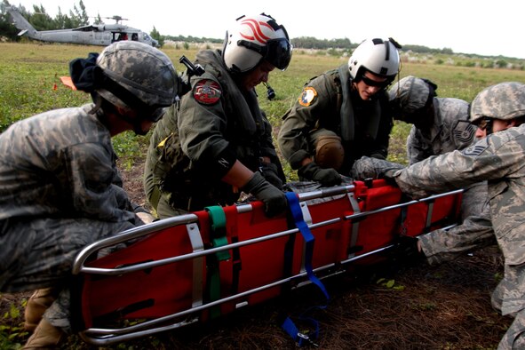 Servicemembers assigned to the 36th Mobility Response Squadron and HSC-25 conduct 9-Line Medical Evacuation training at Northwest Field Oct. 13. The joint field training exercise was performed in an effort to interchange and familiarize themselves with each other?s tactics, techniques and procedures to be able to interoperate and conduct joint Humanitarian Assistance/Disaster Relief missions in the Pacific region. (U.S. Air Force photo/Airman 1st Class Anthony Jennings)