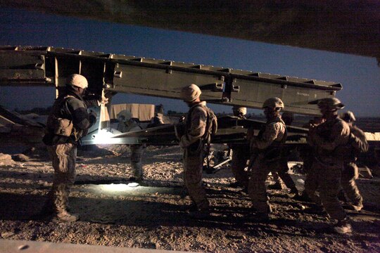Marines with Bridge Platoon, Company A, 9th Engineer Support Battalion, 1st Marine Logistics Group (Forward), removed an old double story medium girder bridge during a bridge replacement project in Marjah, Afghanistan. The Marines removed an old medium girder bridge and replaced it with a newer one, to be used by coalition forces and local nationals.