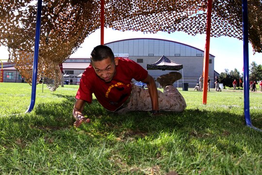 Lance Cpl. Joson J. Ramirez, field radio operator, 9th Communication Battalion, I Marine Expeditionary Force, crawls through an obstacle during Camp Pendleton’s 2010 Leatherneck Field Meet at the 11 Area field, Oct. 27. The Leatherneck Field Meet is a competition for Marines to compete against other units to build camaraderie and esprit de corps.