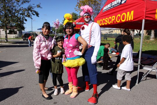 (From left to right) Anetzy, Daisy, Rosie and Kevin Day, dressed up in their best Halloween attire during the third annual Harvest Festival at the Blinder Memorial field, Oct. 30. The event was an opportunity to give Marines, sailors and their families a chance to experience a safe and fun affair and allowed participants to enjoy activities while showing off their best Halloween costumes.