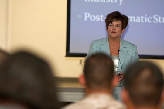 Deborah R. Collins, executive director for the National Security Training Institute, presents her Violence in the Workplace security briefing to dozens of service members and employees assigned to U.S. Marine Corps Forces, Pacific, Sept. 10 at the MarForPac headquarters building, Camp H. M. Smith, Hawaii. Collins uses her firsthand experience as a survivor of the 1988 shooting at Electromagnetic Systems Labs to teach the warning signs and how to handle a potentially violent employee.