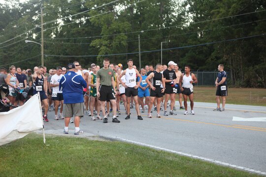 Runners wait to cross the starting line during the Marine Corps Community Services’ 24th annual Marine Corps Half Marathon aboard Marine Corps Base Camp Lejeune, Sept. 25.  More than 200 service members, families, Department of Defense civilians, retired military personnel and handcyclists participated in the 13.1-mile race.