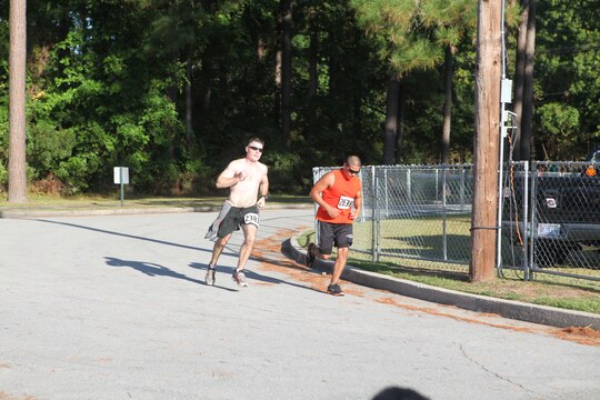 Runners sprint to the finish line during the Marine Corps Community Services’ 24th annual Marine Corps Half Marathon aboard Marine Corps Base Camp Lejeune, Sept. 25.  The athletes ran 13.1 miles, and everyone who crossed the finish line received a T-shirt, towel and race medal.