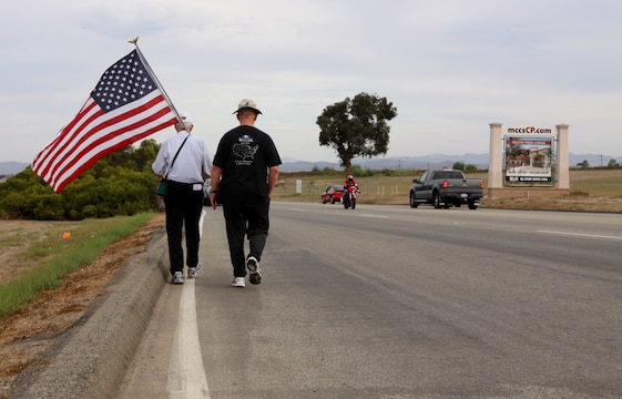 Anthony A. LoBue, better known as Tony the Vet (left), embarks on his journey near Camp Pendleton’s Main Gate with his close friend Robert F. Satterfield, a retired Navy chaplain, Sept. 28. Tony is walking across America in hopes to be at Ground Zero, by Sept. 11, 2011.