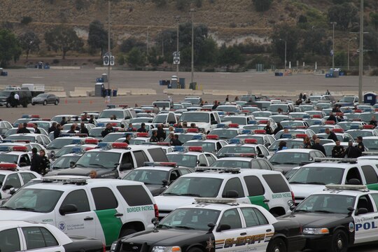 Hundreds of law enforcement vehicles, fire trucks and ambulances from several different police departments were parked in the Qualcomm Stadium parking lot Aug. 12. The vehicles were part of a funeral procession for Police Officer Jeremy Henwood that led to memorial services at the Rock Church.