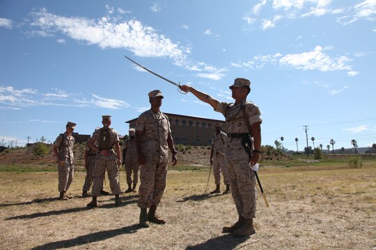 A Marine with 1st Marine Logistics Group draws his noncommissioned officer sword, as an instructor critiques him during the close-order drill portion of the Combat Logistics Regiment 17 Corporals’ Course at Camp Pendleton, Calif., Aug. 17. The corporals attending the course learned basic leadership skills needed to lead the Marines under their charge. They also learned small unit leadership, Marine Corps common skills, sword manual and other Marine Corps knowledge.