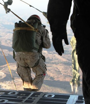 Pfc. William J. Zablatzky, a parachute rigger for Air Delivery Platoon, Landing Support Company, Combat Logistics Regiment 17, 1st Marine Logistics Group, jumps off the cargo bay hatch of a C-130 aircraft during a personnel jump over the hills of Camp Pendleton, Calif., Aug. 23. The primary purpose of the jump was to get jump masters qualified for operations.