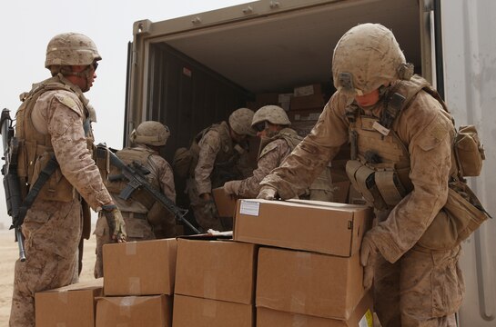 Pfc. Timothy Leicht (left), a motor transportation operator with Combat Logistics Battalion 6, 2nd Marine Logistics Group (Forward) and Lance Cpl. Brant Day (right), a 2nd MLG (FWD) food service specialist currently attached to 3rd Reconnaissance Battalion, load a shipping pallet with fresh and frozen foods at Patrol Base Alcatraz, Aug. 26. Day, along with another food service Marine, will prepare the food for the troops operating at the austere base. (U.S. Marine Corps photo by Sgt. Justin J. Shemanski)