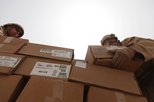 Pfc. Timothy Leicht (left), a motor transportation operator with Combat Logistics Battalion 6, 2nd Marine Logistics Group (Forward) and Lance Cpl. Brant Day (right), a 2nd MLG (FWD) food service specialist currently attached to 3rd Reconnaissance Battalion, load a shipping pallet with fresh and frozen foods at Patrol Base Alcatraz, Aug. 26. Day, along with another food service Marine, will prepare the food for the troops operating at the austere base. (U.S. Marine Corps photo by Sgt. Justin J. Shemanski)