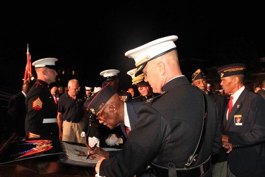 George Kidd, a Montford Point Marine, signs the guestbook at the conclusion of the last Friday Evening Parade of the season at Marine Barracks Washington Aug. 26, 2011. Kidd, along other original Montford Point Marines, was one of the guests of honor the event. In 1942, President Roosevelt established a presidential directive giving African Americans an opportunity to be recruited into the Marine Corps. These African Americans, from all states, were not sent to the traditional boot camps of Parris Island, South Carolina and San Diego, California. Instead, African American Marines were segregated - experiencing basic training at Montford Point - a facility at Camp Lejeune, North Carolina. Approximately 20,000 African American Marines received basic training at Montford Point between 1942 and 1949.::r::::n::