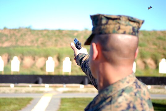A Marine takes aim during the pistol team match portion of the annual Depot Competition in Arms. The contest included recruiters who, due to assignment away from Marine Corps facilities, have had little chance to practice their marksmanship.