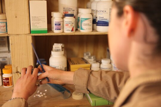 Navy Lt. Sarah Ballard readies a prescription for one of her Marines with Marine Heavy Helicopter Squadron 352, 3rd Marine Aircraft Wing (Forward), at the Flightline Aid Station aboard Camp Bastion, Afghanistan, Jan. 17.  Ballard was selected for the Richard Luehrs Memorial Award as the operational flight surgeon of the year for her superior dedication and accomplishments while deployed.