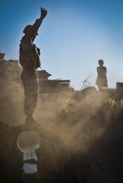 Lance Cpl. Geoffrey Smith, an engineer equipment operator with Combat Logistics Battalion 3, 1st Marine Logistics Group (Forward), directs a heavy equipment vehicle during a road repair project near Katoray, Afghanistan, Jan. 25. Marines with CLB-3's Engineer Company have completed more than 10 miles of road repair on the most heavily trafficked route in Afghanistan's Helmand province.