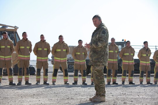 U.K. Royal Air Force Group Captain Guy van den Berg, the commanding officer of the 903rd Expeditionary Air Wing and airfield manager, addresses U.K. and U.S. firefighters during an awards ceremony aboard Camp Bastion, Afghanistan, Jan. 25.  U.K. firefighters and Marines from the Aircraft Rescue and Firefighting section of Marine Wing Support Squadron 373, 3rd Marine Aircraft Wing (Forward), received letters of appreciation for their superior service while working in a joint environment aboard Camp Bastion.