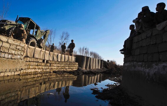 Marines with Combat Logistics Battalion 3, 1st Marine Logistics Group (Forward), use heavy equipment vehicles to repair a portion of road near Katoray, Afghanistan, Jan 27. Marines with CLB-3's Engineer Company have completed more than 10 miles of road repair on the most heavily trafficked route in Afghanistan's Helmand province.