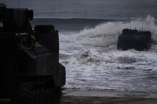 An Amphibious Assault Vehicle splashes into the shoreline of Camp Pendleton’s Red Beach as part of a training exercise, July 26. More than 550 Marines from 4th Assault Amphibian Battalion reserve unit came to base as part of their annual training exercises to practice amphibious assault tactics.