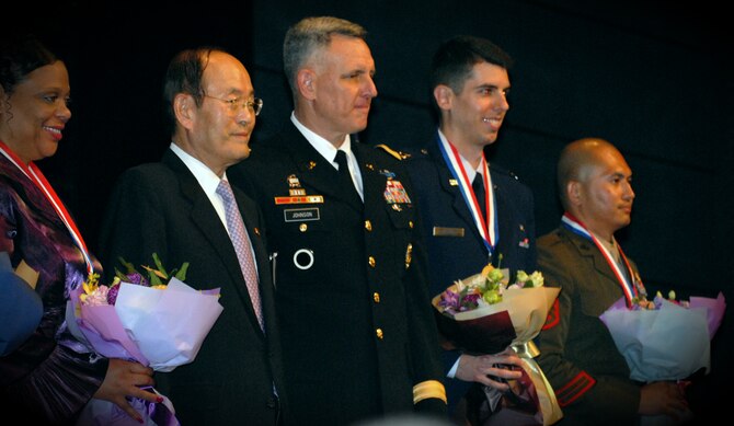 SEOUL, Republic of Korea -- Following the presentation of the Korea America Friendship Society Award 2011 to recipients, they, along with event leaders, pose for photos at the 20th Annual Korea America Friendship Night here June 30. (U.S. Air Force photo/Senior Airman Benjamin Stratton)
