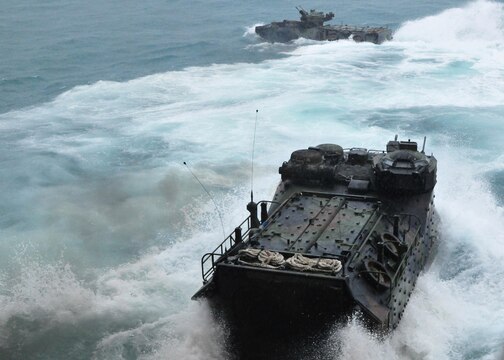 Amphibious assault vehicles with 4th Assault Amphibian Battalion plunge from the landing dock ship, USS Tortuga (LSD 46) to conduct an amphibious assault exercise May 18.  Marines from 2nd Battalion, 23rd Marine Regiment are embarked aboard the AAVs as part of Cooperation Afloat Readiness and Training (CARAT) 2011.  CARAT is a series of bilateral exercises held in Southeast Asia to strengthen relationships and enhance force readiness. (U.S. Navy photo by Mass Communication Specialist 2nd Class Katerine Noll/Released)