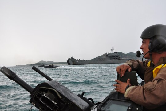 Sgt. Michael Uybungco, vehicle commander, 4th Assault Amphibian Battalion, 4th Marine Division, directs his amphibious assault vehicle past Royal Thai Navy medium landing ship HTMS Surin (LST 722) during an amphibious assault exercise May 18, as part of Cooperation Afloat Readiness and Training (CARAT) 2011.  This AAV was part of the second wave to hit the beach during a bilateral landing exercise with the Royal Thai Navy and Marine Corps.  The landing force, comprised primarily of reserve Marines from 2nd Battalion, 23rd Marine Regiment, was delivered to shore from the landing dock ship USS Tortuga (LSD 46) by Uybungco and fellow ‘trackers’ from his battalion. (U.S. Navy photo by Lt. K. Madison Carter)