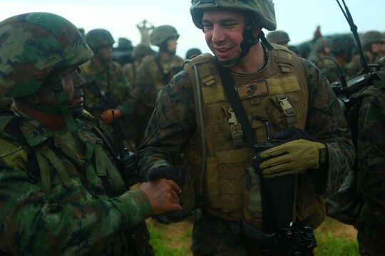 Lance Cpl. Adam Carty, rifleman, 1st Platoon, Landing Force Company, shakes hands with a Royal Thai Marine after completing the final training exercise in Thailand for Cooperation Afloat Readiness and Training (CARAT) 2011. The FTX is an amphibious assault exercise that demonstrates interoperability between U.S. and Royal Thai Marines and Sailors. Carty, a Danville, Calif. native is among the volunteer reservists comprising Landing Force CARAT.  The U.S. Marine Corps Reserve is an integral element of the Marine Corps Operating Forces and shares the expeditionary mindset that encompasses the Marines’ culture.