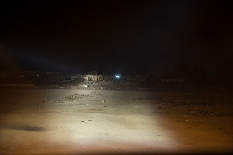 U.S. Army Soldiers from the Minnesota Army National Guard's B-Troop, 1-94 Cavalry, Pine City MN., use a searchlight to inspect a building for threats in Tikrit, Iraq on Oct. 27, 2011. B-Troop is providing security for a convoy of 43 vehicles tasked with hauling equipment and supplies out of Iraq. (U.S. Air Force Photo/Master Sgt. Jeffrey Allen)