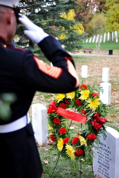 Sgt. Maj. Micheal P. Barrett, sergeant major of the Marine Corps, salutes the grave of Cpl. Rene Gagnon, one of the flag raisers from the famous Iwo Jima photograph, during a wreath-laying ceremony at Arlington National Cemetery Nov. 10. In honor of the Marine Corps birthday, six teams from Marine Barracks Washington, including Barrett and the assistant commandant of the Marine Corps, visited various graves of former commandants and sergeants major of the Marine Corps in the National Capital Region to honor those former leaders of the Corps.