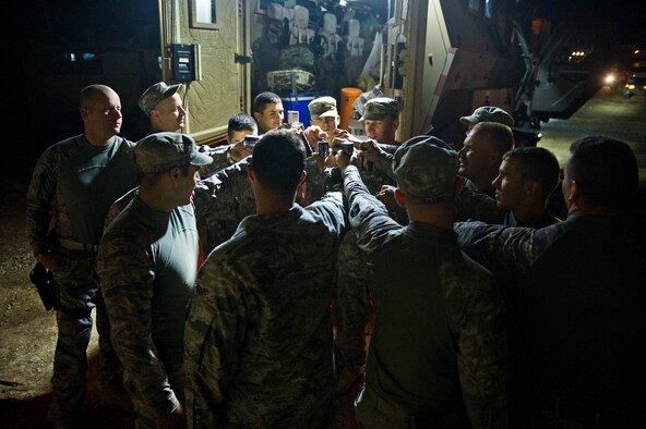 Members of the U.S. Air Force's 70th medium truck detachment and the U.S. Army Minnesota National Guard's B-Troop, 1-94 Cavalry, Pine City MN., prepare for their convoy pre-departure ritual of chugging energy drinks on Oct. 29, 2011. The team's convoy of 43 vehicles and 60 passengers is about to make the final run on a seven day, 1,100 mile mission to haul equipment and supplies out of Iraq. (U.S. Air Force Photo/Master Sgt. Jeffrey Allen)