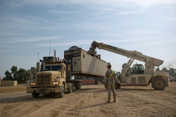 A shipping container loaded with supplies and equipment is loaded on to a U.S. Air Force M915 tractor trailer at Joint Base Balad, Iraq on Oct. 29, 2011.  (U.S. Air Force Photo/Master Sgt. Jeffrey Allen)