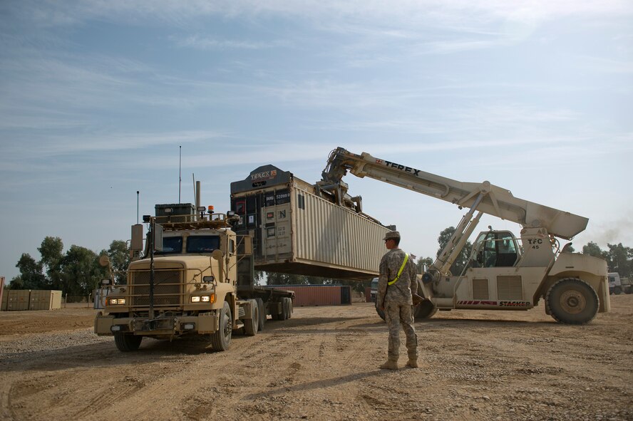 A shipping container loaded with supplies and equipment is loaded on to a U.S. Air Force M915 tractor trailer at Joint Base Balad, Iraq on Oct. 29, 2011.  (U.S. Air Force Photo/Master Sgt. Jeffrey Allen)