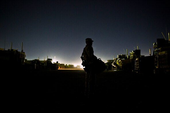 U.S. Air Force Tech. Sgt. David Perez, convoy commander, 70th medium truck detachment and Santa Fe, NM. native, walks through a sea of parked trucks after completing the first leg of a seven day convoy on Oct. 22, 2011. Perez is responsible for leading a convoy of 43 vehicles and 60 passengers more than 1,100 miles through Iraq. During the trip, the convoy will travel to several bases before getting to their designated load point. (U.S. Air Force Photo/Master Sgt. Jeffrey Allen)
