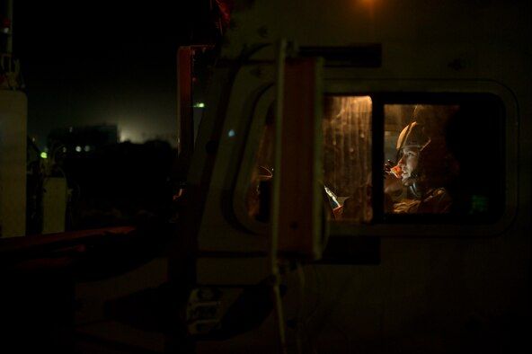 U.S. Air Force Tech. Sgt. David Perez, convoy commander, 70th medium truck detachment and Santa Fe, NM. native, coordinates with his headquarters after completing the first leg of a seven day convoy on Oct. 22, 2011. Perez is responsible for leading a convoy of 43 vehicles and 60 passengers more than 1,100 miles through Iraq. Members of the 70th MTD are hauling equipment out of Iraq to meet the deadline for the U.S. military transition from Iraq. (U.S. Air Force Photo/Master Sgt. Jeffrey Allen)