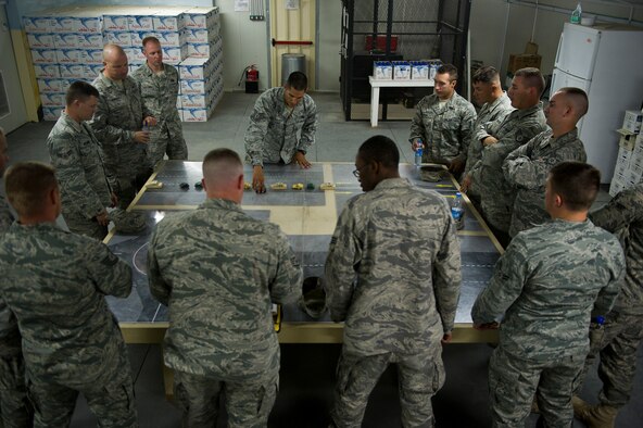 U.S. Air Force Tech. Sgt. David Perez, convoy commander, 70th medium truck detachment and Santa Fe, NM native, briefs his team on convoy tactics during a "rock drill" before departing on a mission to transport equipment out of Iraq on Oct. 22, 2011. Perez is responsible for moving a convoy of 43 vehicles and 60 passengers more than 1,100 miles through Iraq. Members of the 70th MTD are hauling equipment out of Iraq to meet the deadline for the U.S. military transition from Iraq. (U.S. Air Force Photo/Master Sgt. Jeffrey Allen)