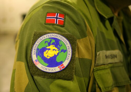 Maj. Kjell Mathisen, Norwegian Defense Logistics Organization/Marine Expeditionary Brigade, executive officer, proudly wears his Marine Corps Prepositioning Program in Norway patch at the Vaernes International Airport, Nov. 14. Marines from MFE and Norwegian soldiers with MCPP-N, would later load more than 28,000 pounds, comprised of 110 cold weather tents, space heaters and fuel cans to be flown to Erzurum, Turkey, to help provide shelter and warmth to more than 1,000 Turkish citizens left homeless by recent earthquakes. “For this joint partnership to be effective, it is important for us to be like a family. While we are normally closed on the weekends, to help the Turkish, we pulled the trigger and everyone was on deck to help,” added Mathisen