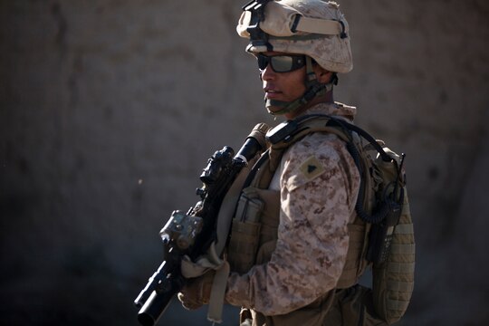 Cpl. Daniel Botero, a combat engineer with the Combat Logistics Battalion 1 Embedded Partnering Team, 2nd Marine Logistics Group (Forward), stands at the entrance of the EPT lot aboard Camp Leatherneck, Afghanistan, Nov. 16.  Botero will celebrate his 21st birthday in Afghanistan later this month, something that he feared he may not experience due to a recent bout with cancer. (U.S. Marine Corps photo by Cpl. Katherine M. Solano)