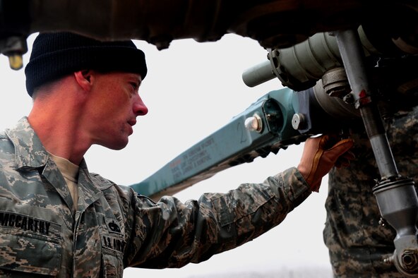 Tech. Sgt. Keith McCarthy, 838th Air Expeditionary Advisory Group Detachment 1, maintenance air adviser, makes sure everything is running smoothly before a training flight over Herat City, Afghanistan, Nov. 10, 2011. U.S. and Salvadoran airmen advise Afghan soldiers on the maintenance, operations and security of the Mi-17 Helicopter. McCarthy is deployed from the 723th Aircraft Maintenance Sq. at Moody AFB, Ga. (U.S. Air Force Photo/SrA Tyler Placie)
