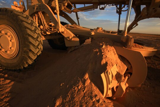 A construction vehicle, operated by a Marine with Combat Logistics Battalion 1, 2nd Marine Logistics Group (Forward), displaces dirt to flatten a new route in Helmand province, Afghanistan, Nov. 22. The Marines with CLB-1 are building Route Victoria to connect districts in the area. (U.S. Marine Corps photo by Cpl. Katherine M. Solano)