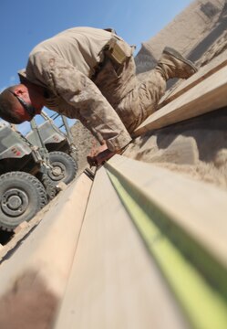 Cpl. Mathew Alsup, of Eugene, Ore., measures a section of lumber during the construction of Patrol Base New Jersey, Afghanistan, Nov. 23. Alsup is a motor transportation operator with Combat Logistics Company 6, 2nd Marine Logistics Group (Forward). The CLC, which is comprised of two engineer platoons and one motor transportation platoon, is an element of Combat Logistics Battalion 6 and was formed to provide direct support to 1st Battalion, 6th Marine Regiment, during Operation Eastern Storm. CLC engineers built several of the patrol bases along Route 611. (U.S. Marine Corps photo by Sgt. Justin J. Shemanski)