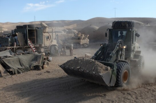 A heavy equipment operator with Combat Logistics Company 6, 2nd Marine Logistics Group (Forward), uses a front loader to haul gravel for a landing zone at Forward Operating Base New Jersey, Afghanistan, Nov. 23. The company, which is comprised of two engineer platoons and one motor transportation platoon, is an element of Combat Logistics Battalion 6 and was formed to provide direct support to 1st Battalion, 6th Marine Regiment, during Operation Eastern Storm. CLC-6 engineers built several of the patrol bases along Route 611. (U.S. Marine Corps photo by Sgt. Justin J. Shemanski)