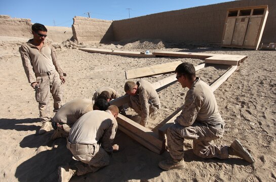 Combat engineers with Combat Logistics Company 6, 2nd Marine Logistics Group (Forward), build an elevated walkway between hygiene facilities at Patrol Base New Jersey, Afghanistan, Nov. 23. The CLC, which is comprised of two engineer platoons and one motor transportation platoon, is an element of Combat Logistics Battalion 6 and was formed to provide direct support to 1st Battalion, 6th Marine Regiment, during Operation Eastern Storm. Engineers were tasked with building several of the patrol bases along Route 611. Once force protection measures were in place, such berms and concertina wire, the Marines then built comfort items that included benches, hygiene facilities and gym equipment for the infantrymen operating from the bases. (U.S. Marine Corps photo by Sgt. Justin J. Shemanski)