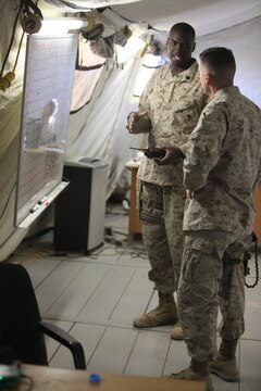 Staff Sgt. Reginald Gibbons, the staff non-commissioned officer in charge of the sort lot aboard Camp Leatherneck, gives a detailed plan for the redeployment and retrograde of excess equipment from Afghanistan to the United States, Nov. 29. The sort lot is responsible for inventorying, cleaning and shipping these supply items as part of Operation Clean Sweep. (U.S. Marine Corps Photo by 2nd Lt. James F. Stenger)