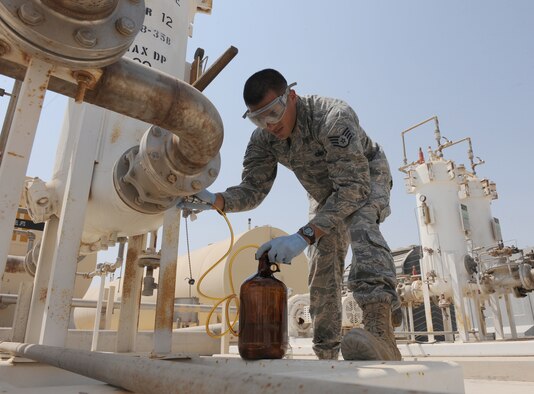 Staff Sgt. Abel Telles, the NCO in charge of the fuels laboratory for the petroleum, oil and lubricants flight in the 380th Expeditionary Logistics Readiness Squadron, pulls a receipt sample from a supplier to assure the fuel meets the proper standards Sept. 30, 2011, at an air base in Southwest Asia. Telles is a native of Santa Maria, Calif. and is deployed from Luke Air Force Base, Ariz. (U.S. Air Force photo/Master Sgt. Chance Babin)