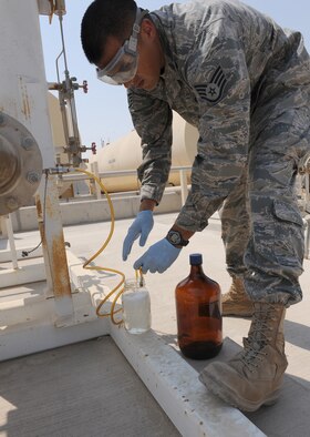 Staff Sgt. Abel Telles, the NCO in charge of the fuels laboratory for the petroleum, oil and lubricants flight in the 380th Expeditionary Logistics Readiness Squadron, pulls a receipt sample from a supplier to assure the fuel meets the proper standards Sept. 30, 2011, at an air base in Southwest Asia. Telles is a native of Santa Maria, Calif. and is deployed from Luke Air Force Base, Ariz. (U.S. Air Force photo/Master Sgt. Chance Babin)