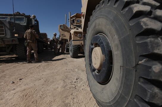 Marines with Combat Logistics Company, Combat Logistics Battalion 6, look over their personal equipment and vehicles prior to leaving Forward Operating Base Nolay, Afghanistan, Oct. 16. The platoon of engineers and other support personnel will spend the next several days building patrol bases in the Upper Sangin Valley. (U.S. Marine Corps photo by Sgt. Justin J. Shemanski)
