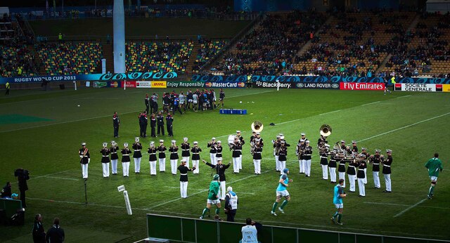 The U.S. Marine Corps Forces, Pacific Band opens the USA versus Ireland match at the Rugby World Cup 2011 in New Plymouth Sept. 11. Chief Warrant Officer 3 Michael Smith,  officer-in-charge, MARFORPAC Band, sings 'Fly like an Eagle' to motivate the American rugby team, who are known as the Eagles.