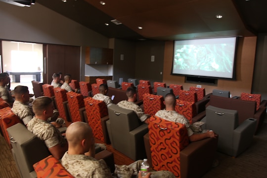 Marines watch a movie in the community center of one of four new bachelor enlisted quarters during a ribbon cutting ceremony in 14 Area, Camp Pendleton, Calif., Sept. 12. The BEQ complex was designed to give Marines a facility they could call home.
