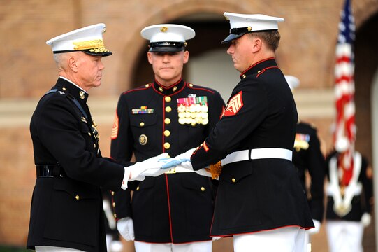 Sgt. Dakota Meyer, the first living Marine Medal of Honor recipient since the Vietnam War, receives the Medal of Honor flag from Gen. James F. Amos, the commandant of the Marine Corps, during the Medal of Honor flag presentation ceremony at Marine Barracks Washington Sept. 16. Meyer was presented the Medal of Honor by President Barack Obama the previous day.