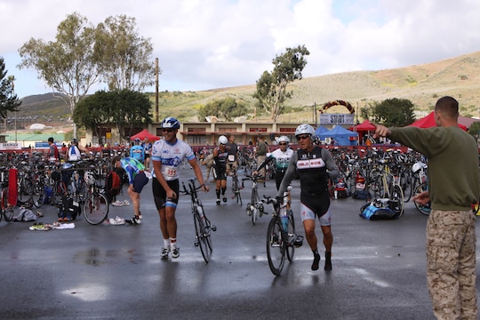 Participants run to exit the run to bike transition area to mount their bikes and begin the 30k cycling, during the Devil Dog Duathlon at Camp Pendleton, Calif., April 14.