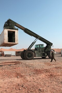 Marines with Marine Aviation Logistics Squadron 16 and Marine Wing Support Squadron 273, move a mobile maintenance facility aboard Camp Bastion, Afghanistan, April 19, 2012. The MALS-16 Marines will send home almost 150,000 pounds of maintenance equipment over the next two days in support of the Marine Corps' mission of downsizing in Afghanistan.